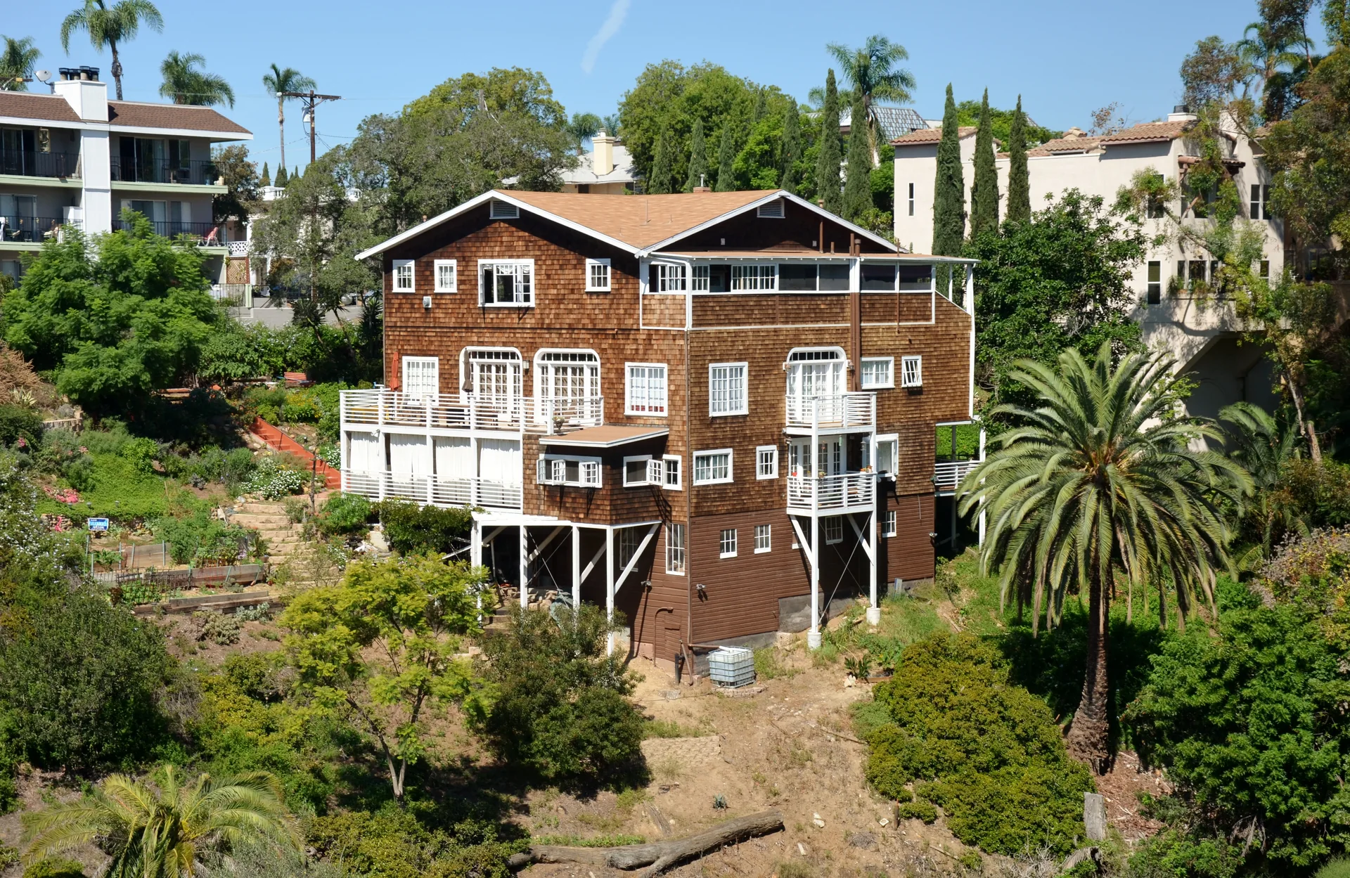 A timber-sided building and planted slope in Bankers Hill, San Diego.